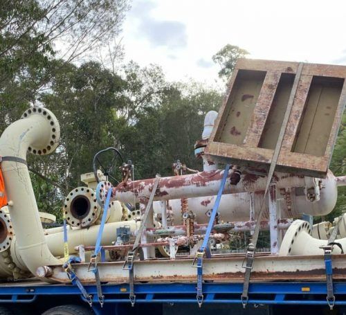 A Blue Truck with A Bunch of Pipes on It — H & H Metal Recycling In Nambour, QLD
