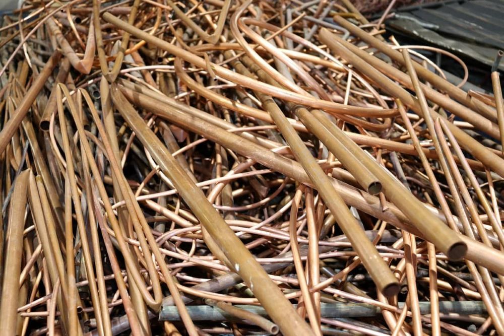 A Pile of Copper Pipes Sitting on Top of Each Other — H & H Metal Recycling In Warana, QLD