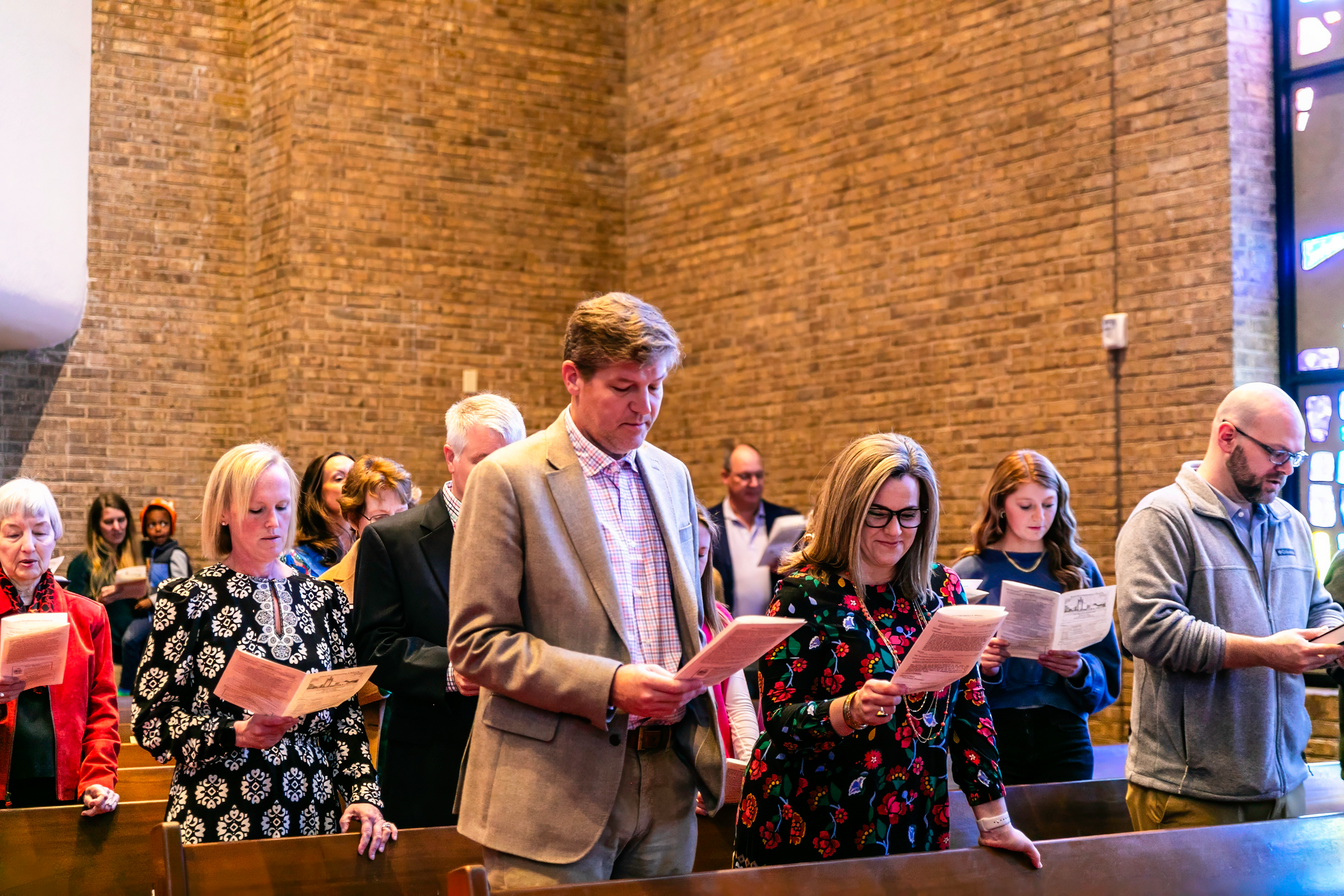 A group of people are singing in a church.