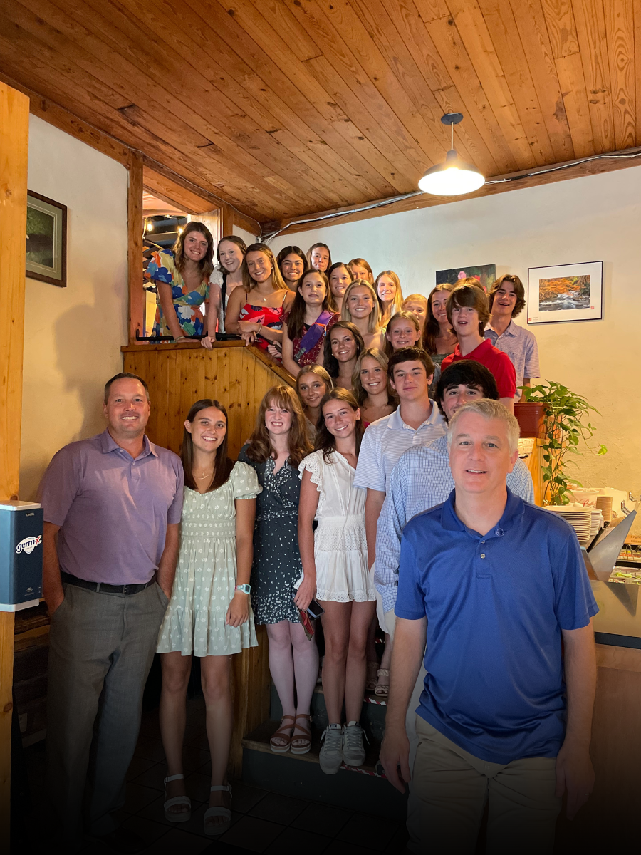 A group of people are posing for a picture in a living room