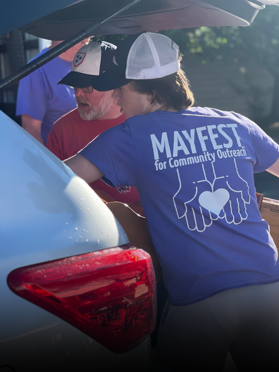 A person wearing a purple mayfest shirt