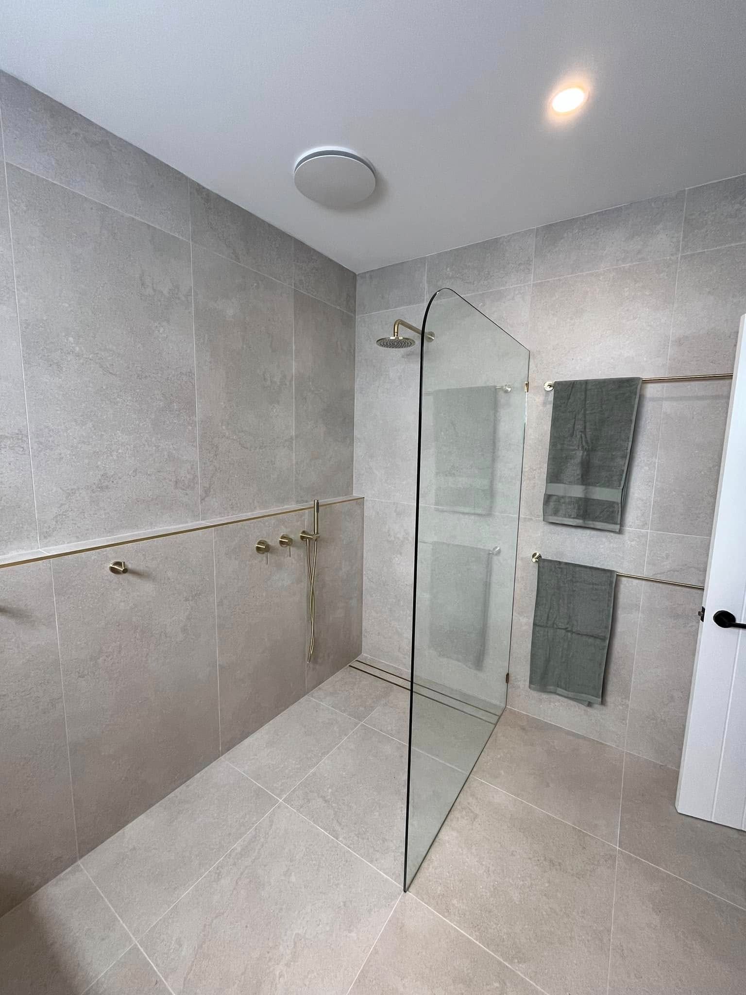 A Modern Bathroom with Grey Tile — Cobra Plumbing & Bathrooms in Heathcote, NSW