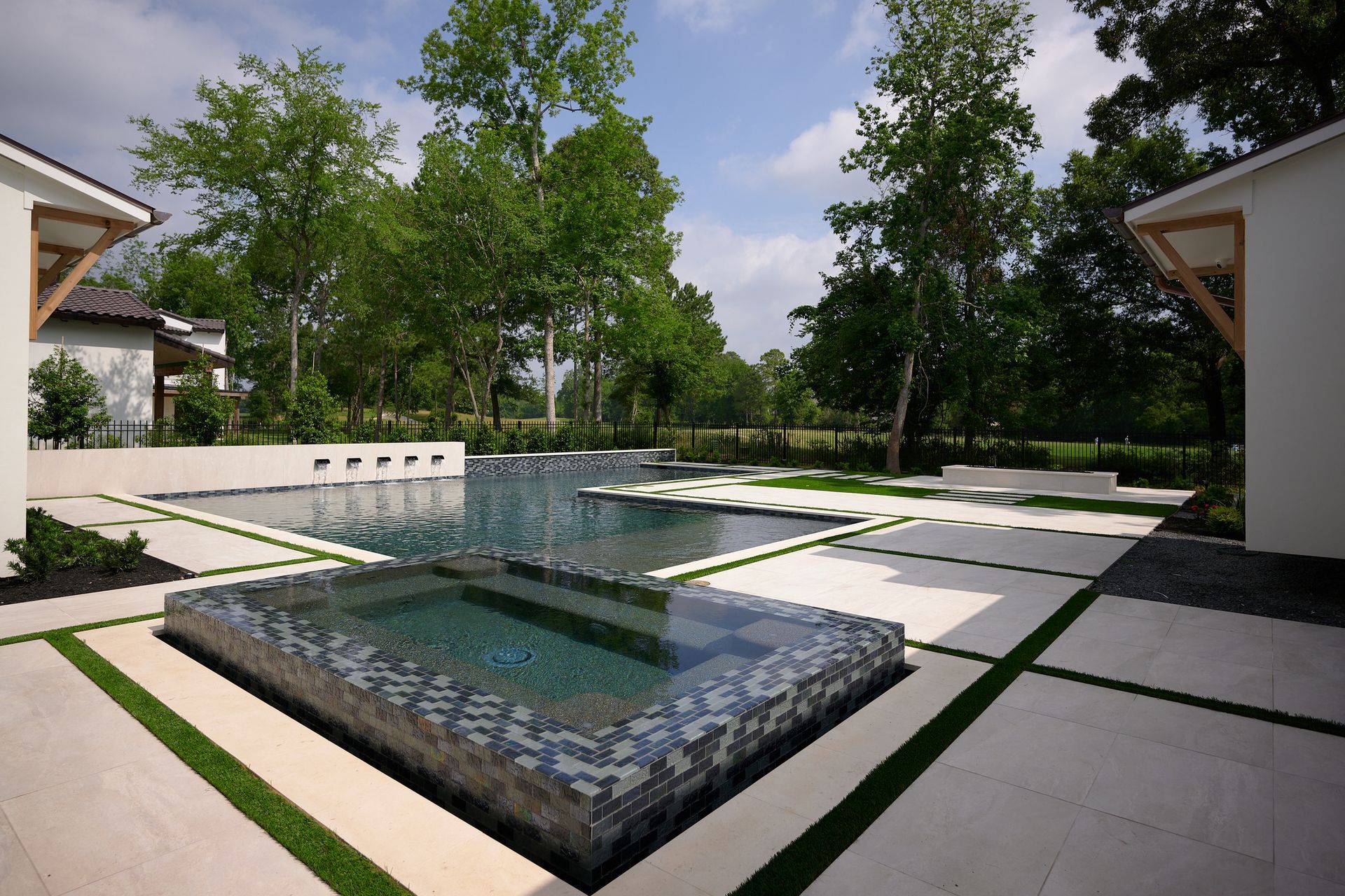 A large swimming pool in the backyard of a house