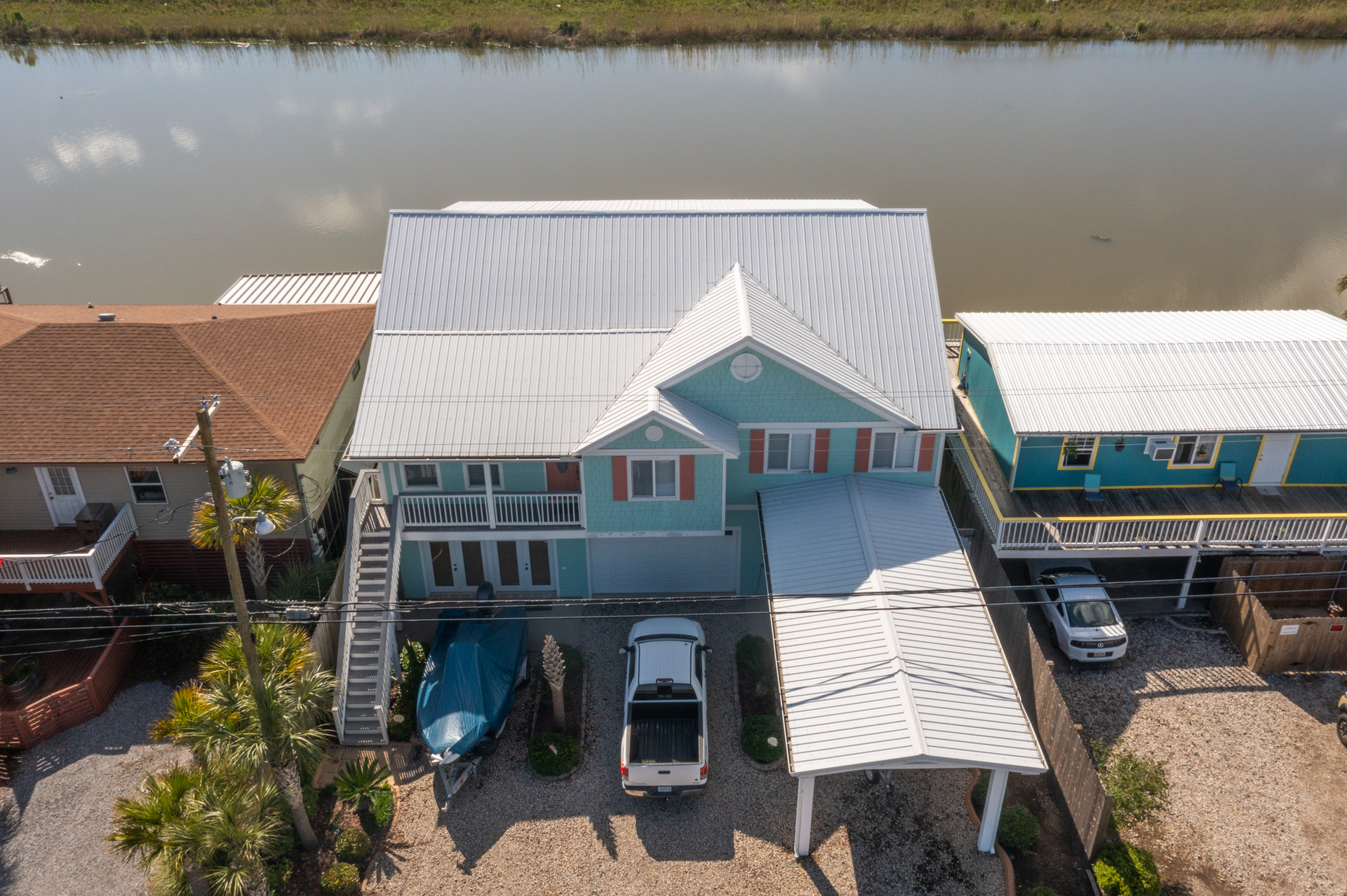 An aerial view of a house with a car parked in front of it.