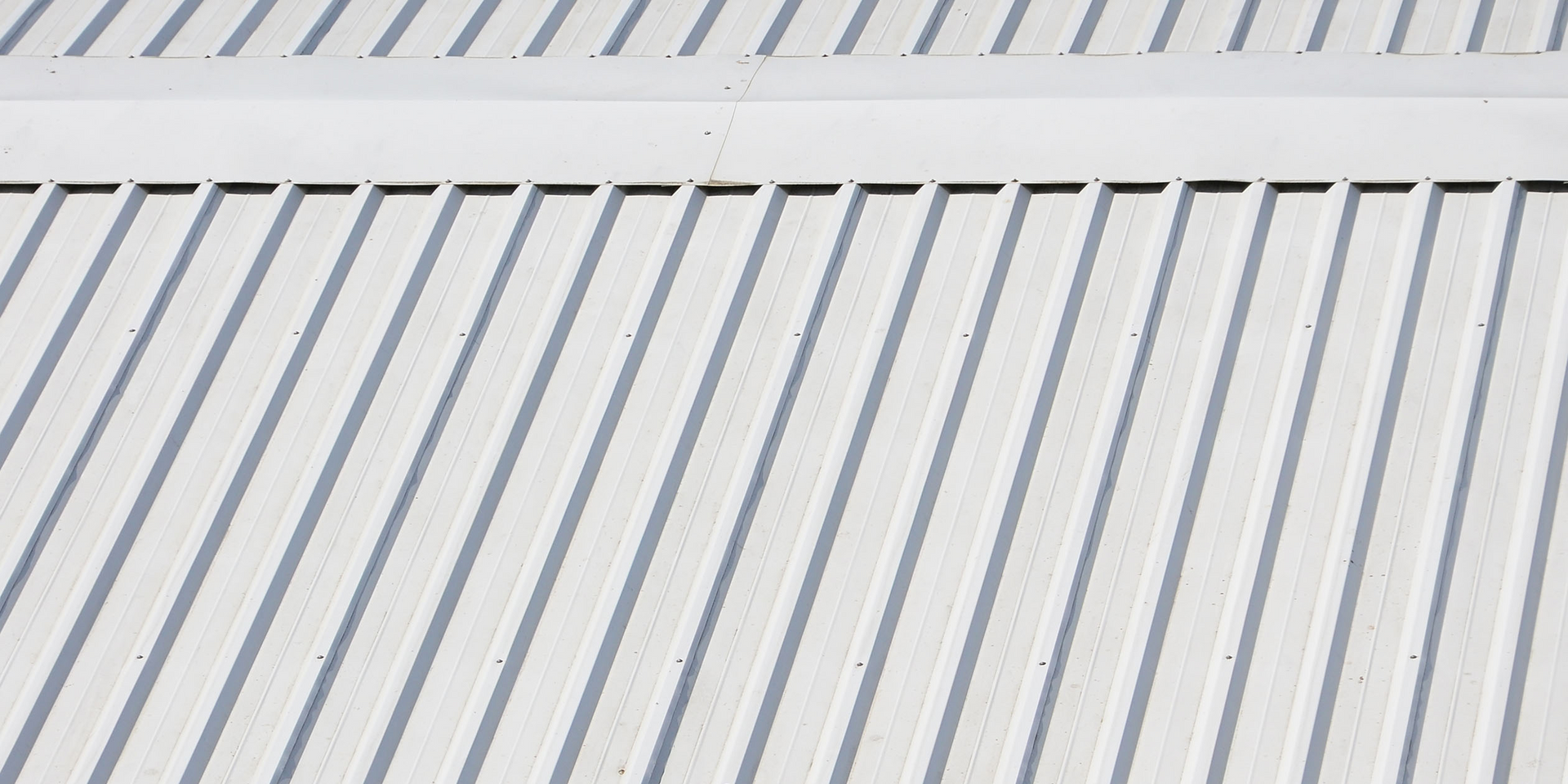 A close up of a white fence with a diagonal pattern