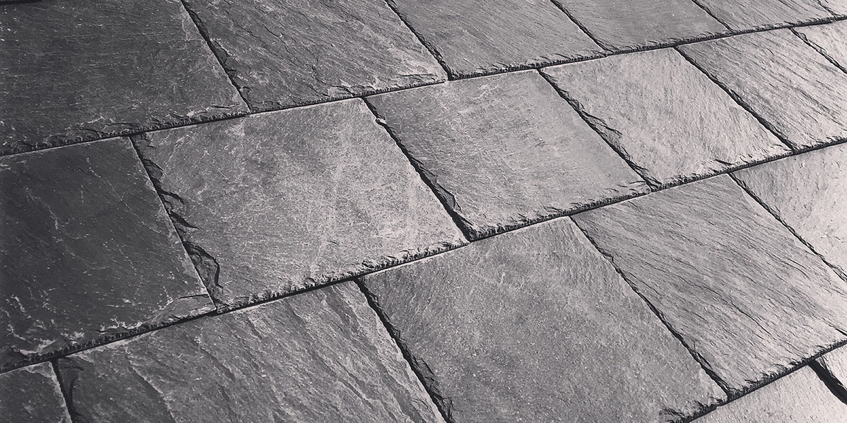 A black and white photo of a slate roof.
