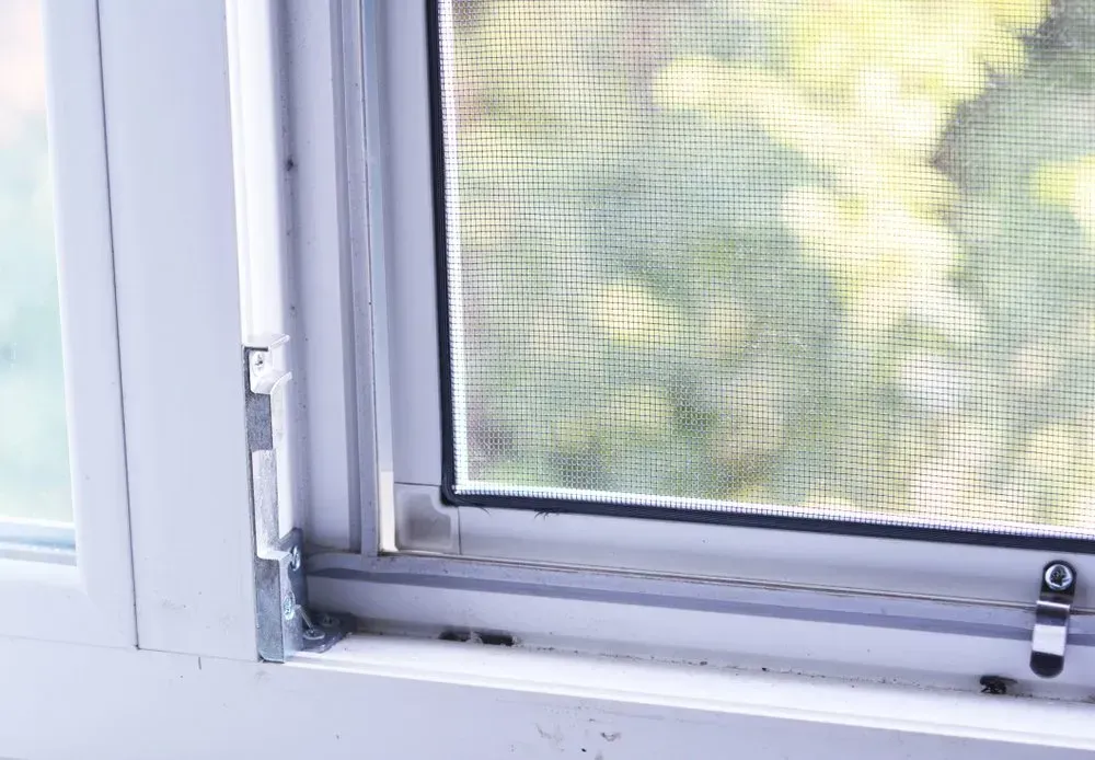 A Close Up Of A Window With A Screen On It — Coastal Blind Installations In Bundaberg, QLD
