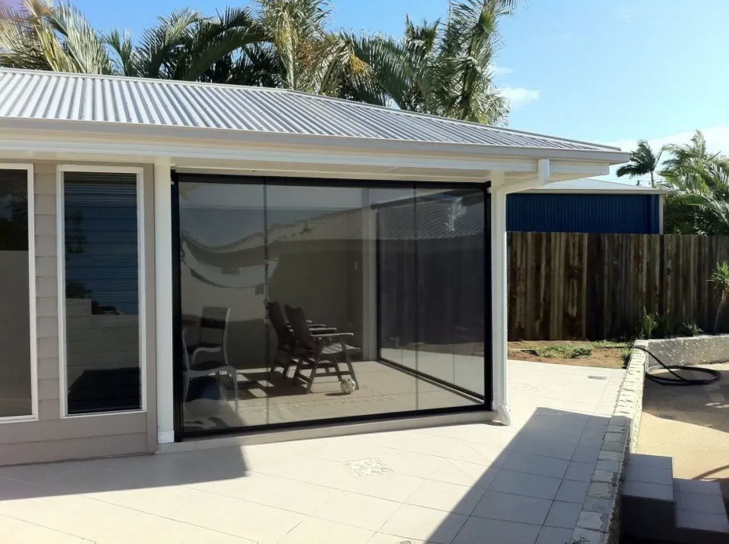A House With A Sliding Glass Door Leading To A Patio — Coastal Blind Installations In Agnes Waters, QLD