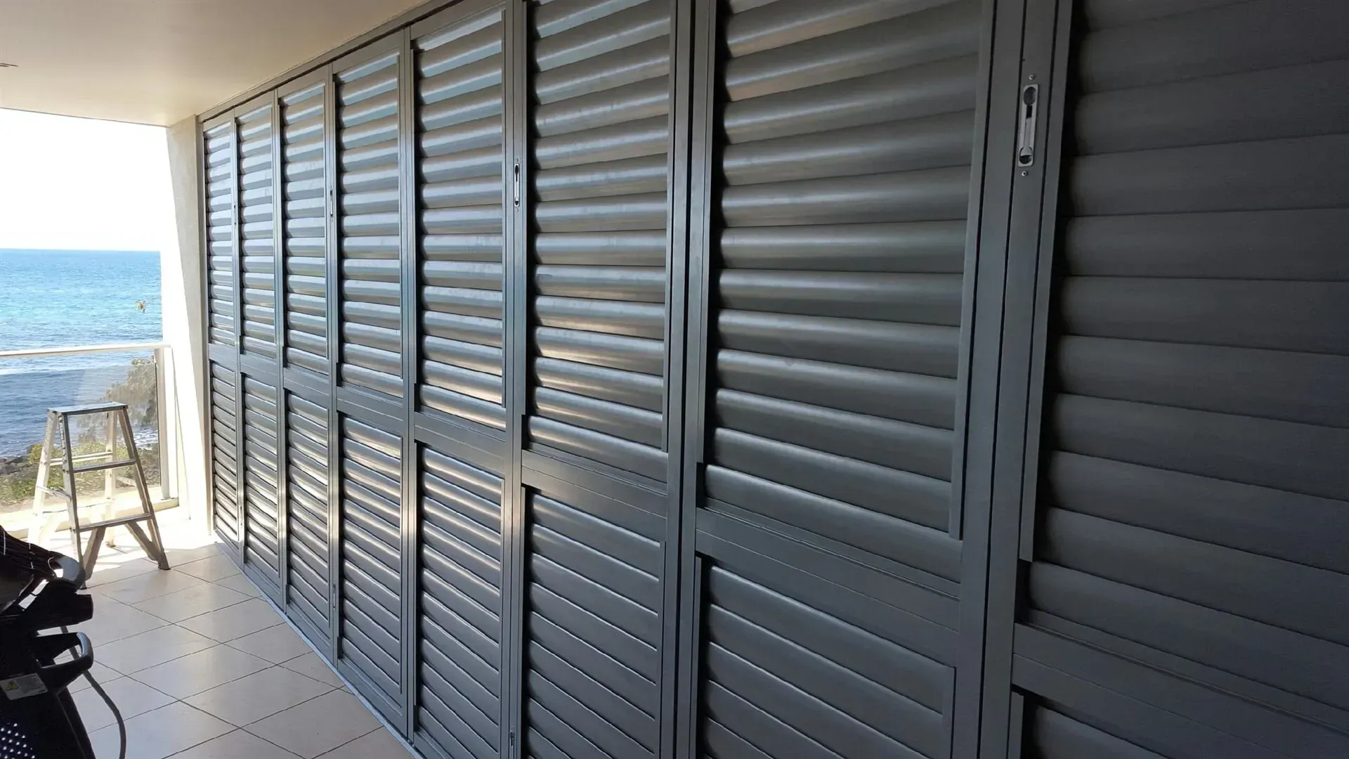A Row Of Shutters On A Wall With A View Of The Ocean — Coastal Blind Installations In Agnes Waters, QLD