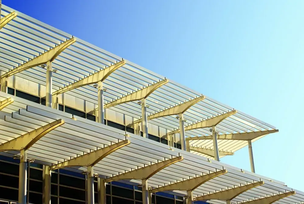 A Building With A Lot Of Windows And A Canopy On Top Of It — Coastal Blind Installations In Bundaberg, QLD