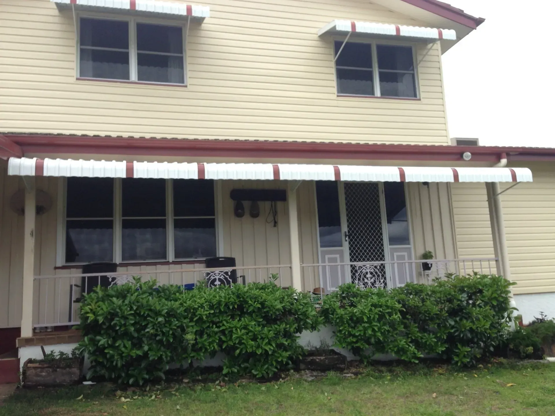 A House With A White Awning On The Front Porch — Coastal Blind Installations In Agnes Waters, QLD