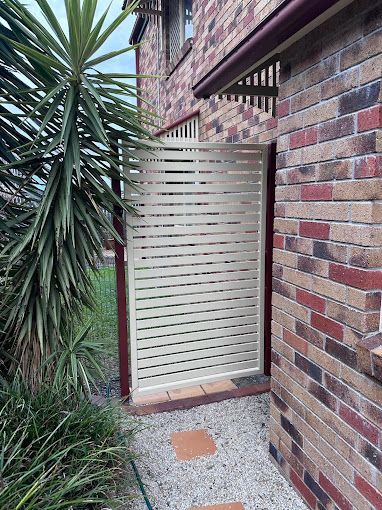 A Close Up Of A Metal Fence With Holes In It — Coastal Blind Installations In Kensington, QLD