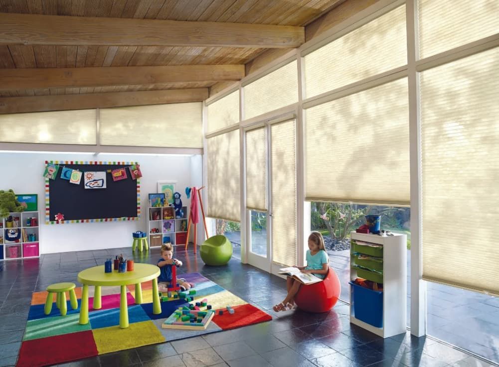 A Girl Is Sitting On A Bean Bag Chair In A Room With Lots Of Windows — Coastal Blind Installations In Kensington, QLD