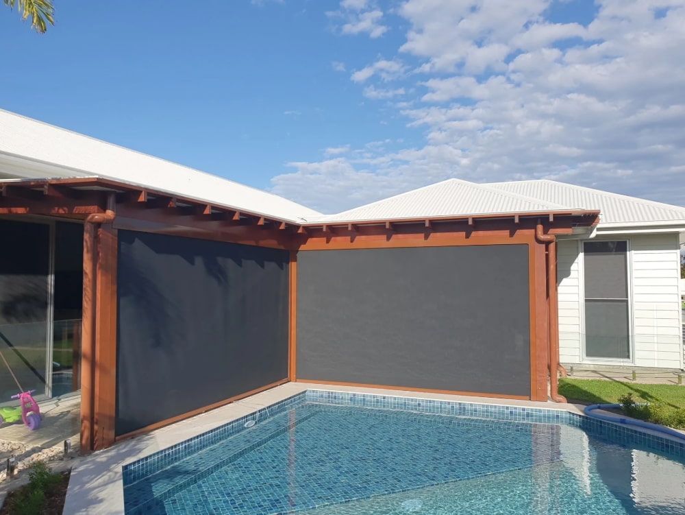 There Is A Swimming Pool In The Backyard Of A House — Coastal Blind Installations In Kensington, QLD