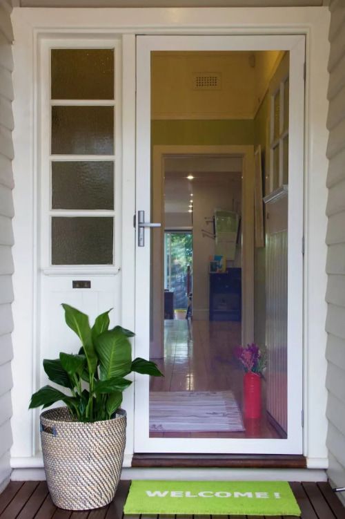 A Potted Plant Sits In Front Of A Door That Says Welcome — Coastal Blind Installations In Kensington, QLD