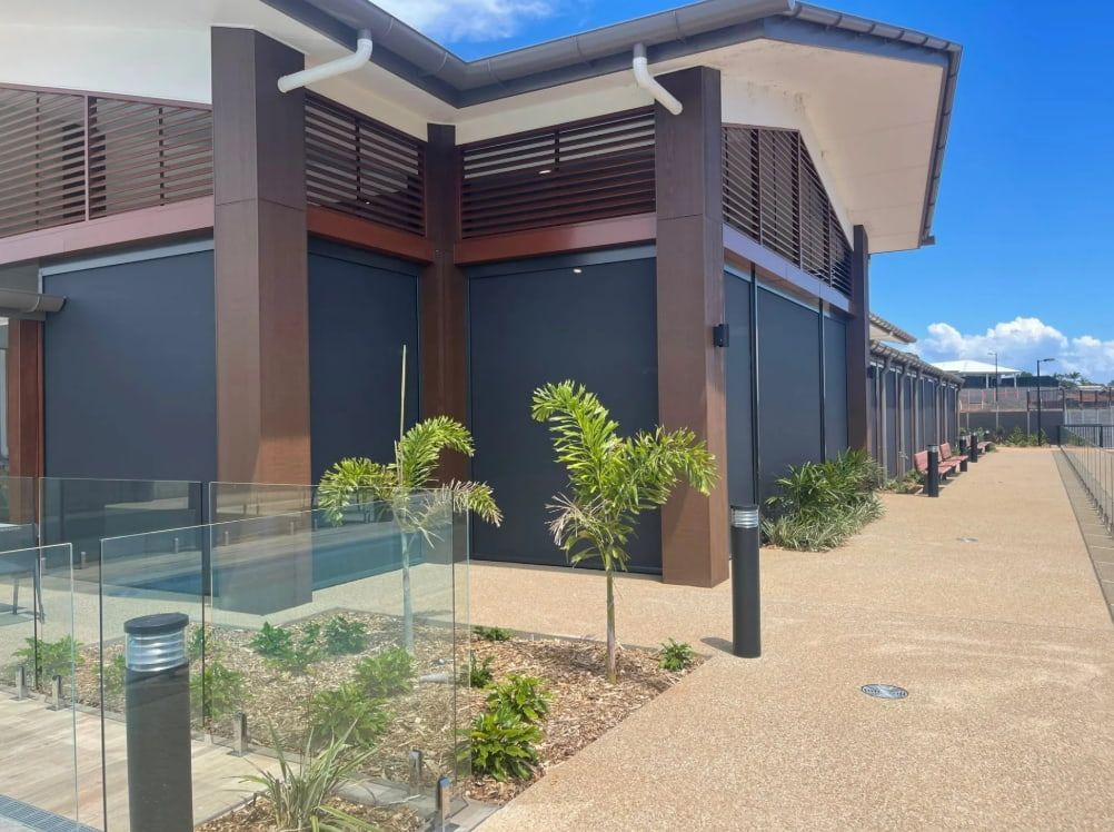A Large Building With A Walkway Leading To It — Coastal Blind Installations In Kensington, QLD