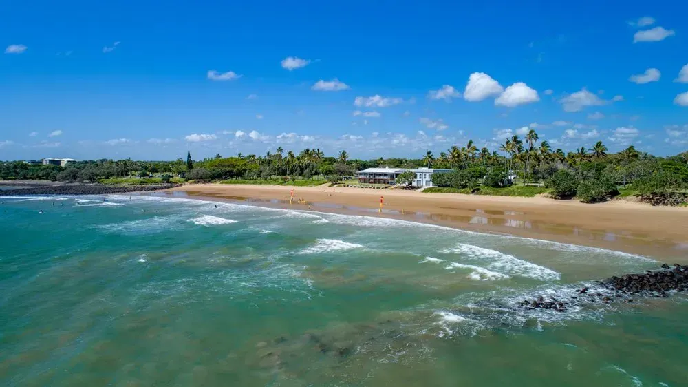An Aerial View Of A Beach With A House In The Distance — Coastal Blind Installations In Bargara, QLD