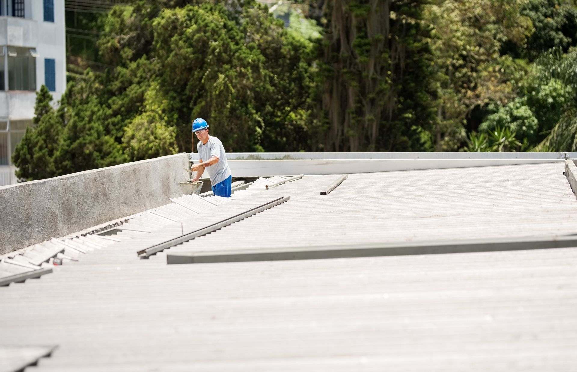 Commercial flat roofing repair worker fixing rooftop leakage | Crystal Lake, IL