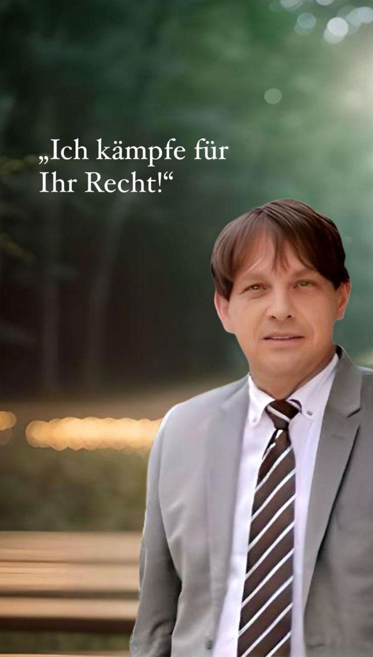 A man in a suit and tie is standing in front of a sign that says ich kampfe fur ihr recht