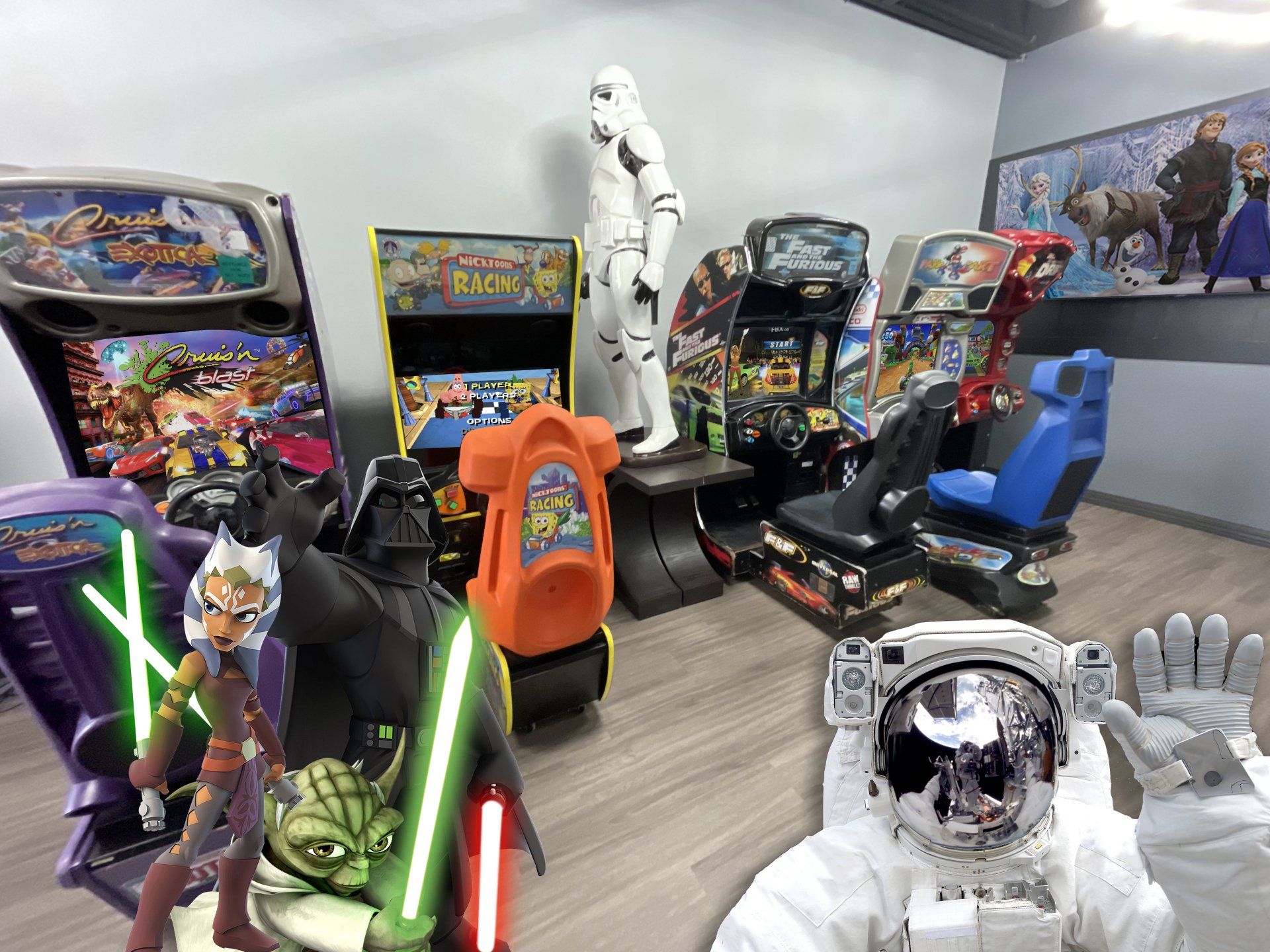 A room filled with various arcade game cabinets, Star Wars character cutouts, and an astronaut posing in the foreground.