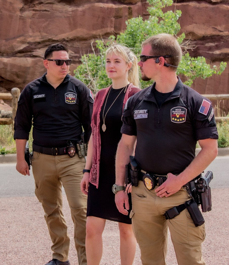 Two police officers and a woman are standing next to each other