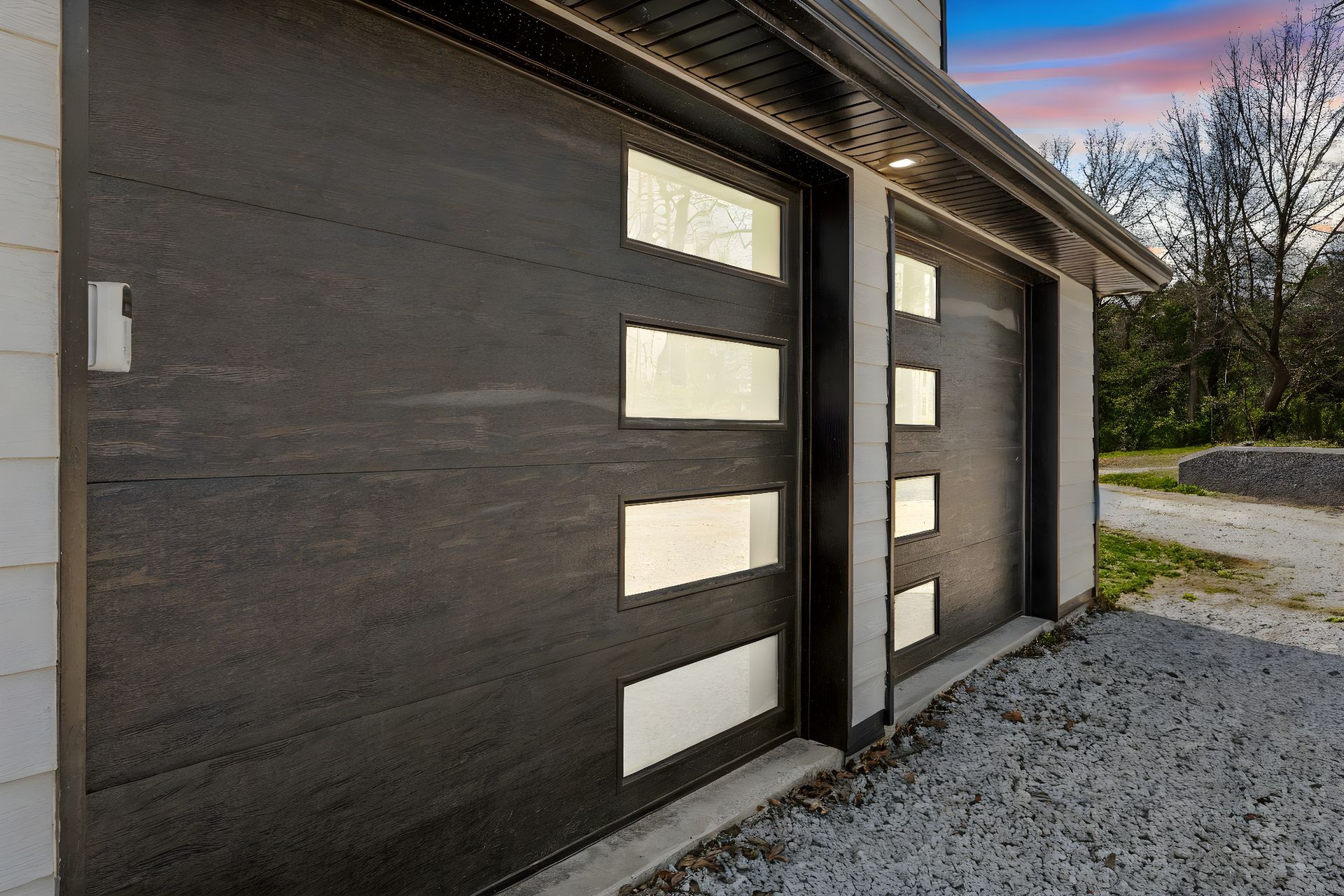 Modern wood-toned garage doors with windows.
