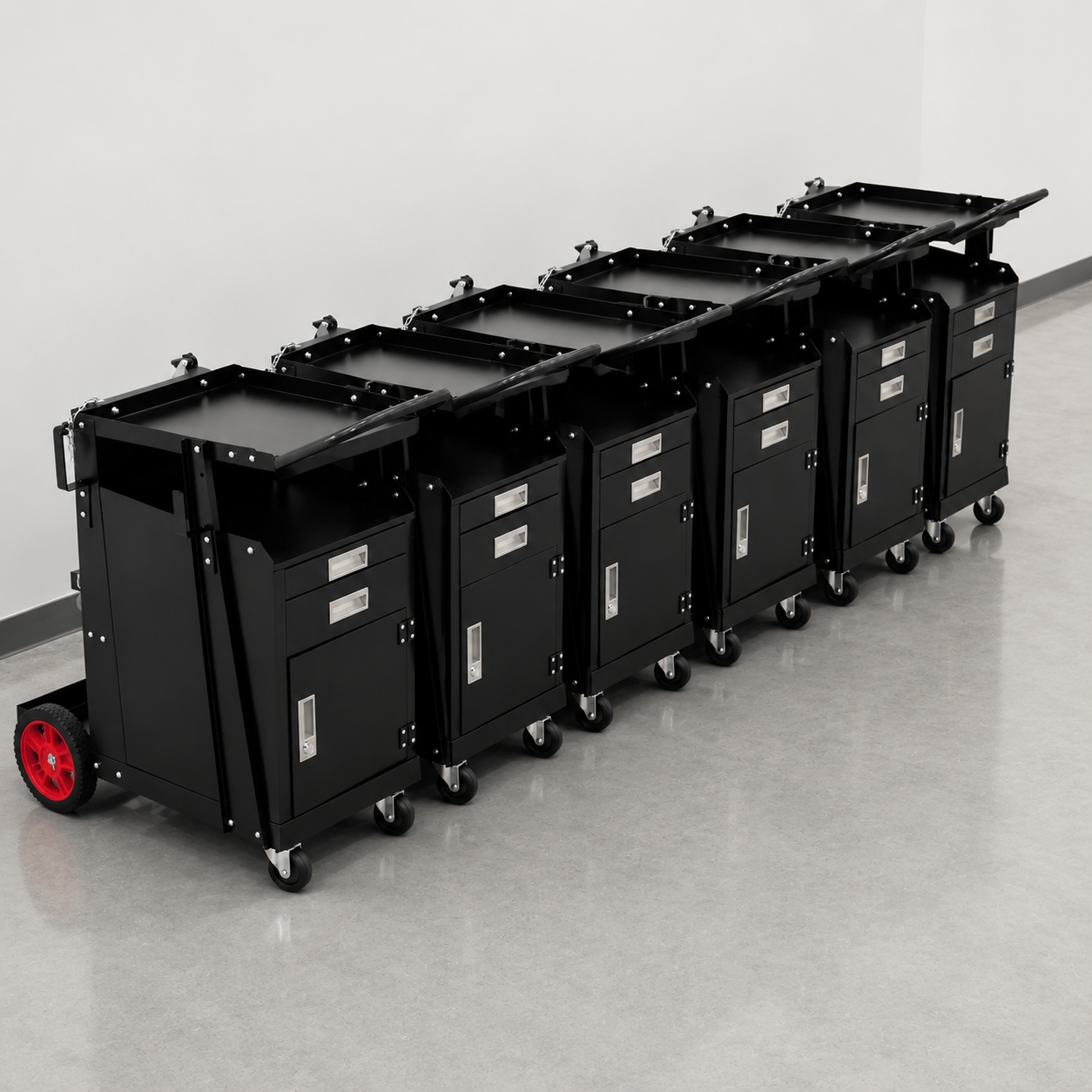 Row of black rolling utility carts with red wheels lined up in a hallway
