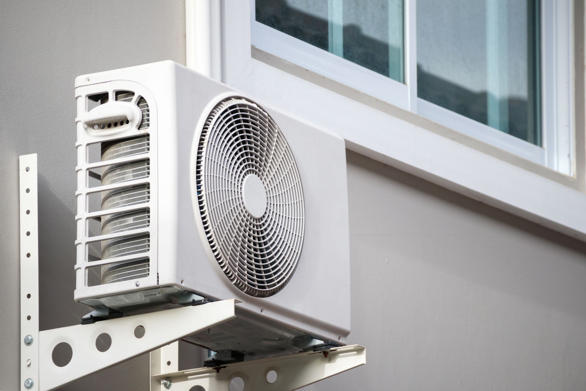 Outdoor air conditioning compressor unit installed by heating and cooling company near you for energy efficiency