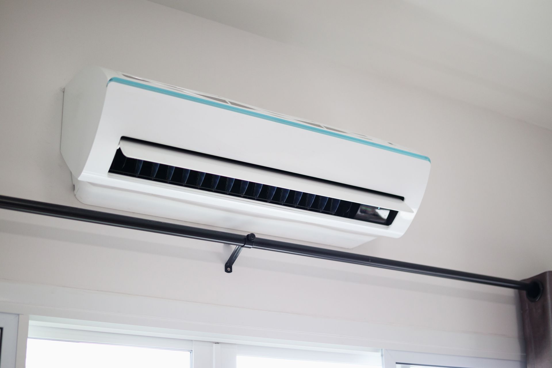Wall-mounted air conditioner installed by HVAC heating and cooling specialists in a residential home
