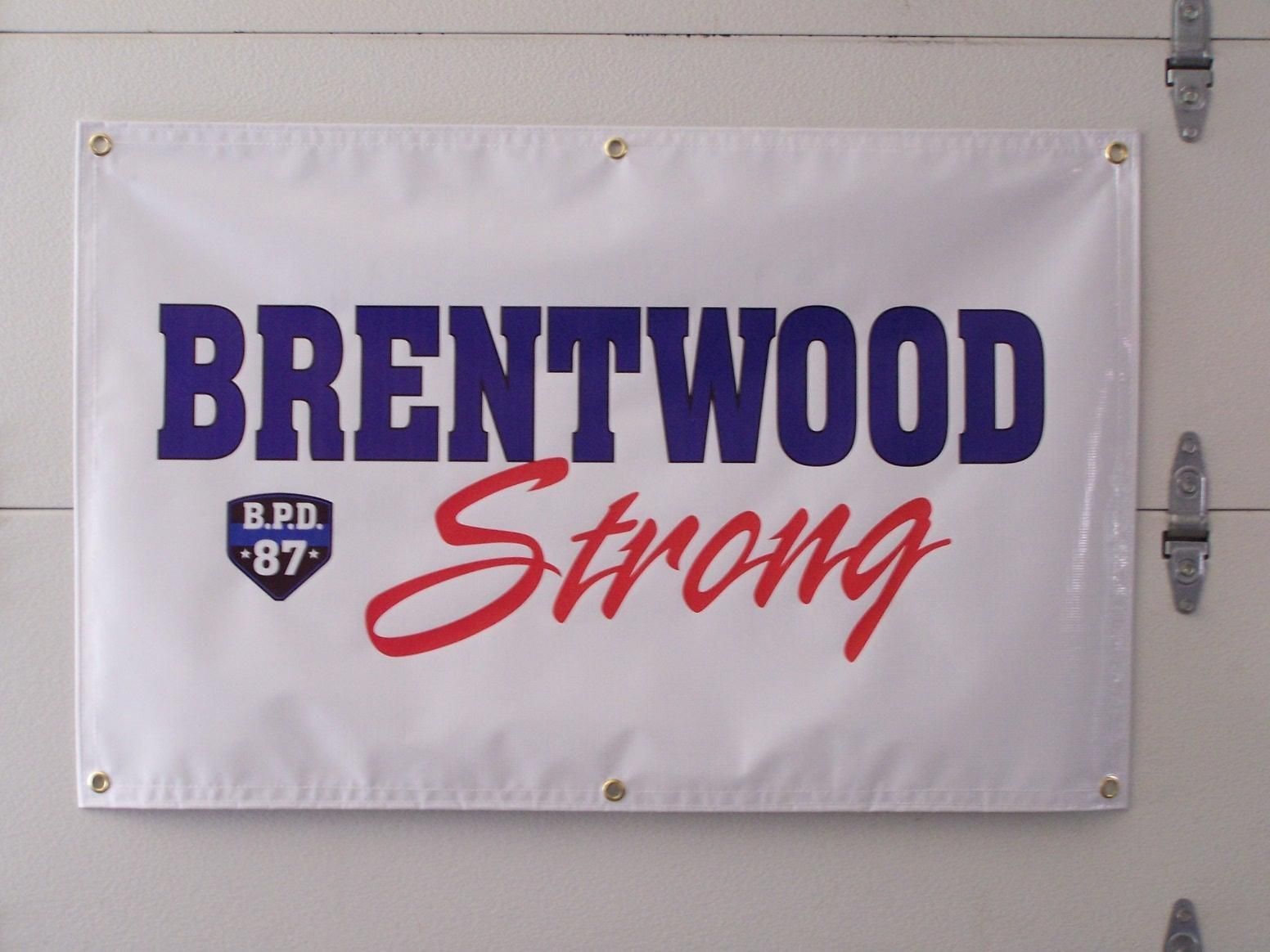 A brentwood strong banner hangs on a garage door