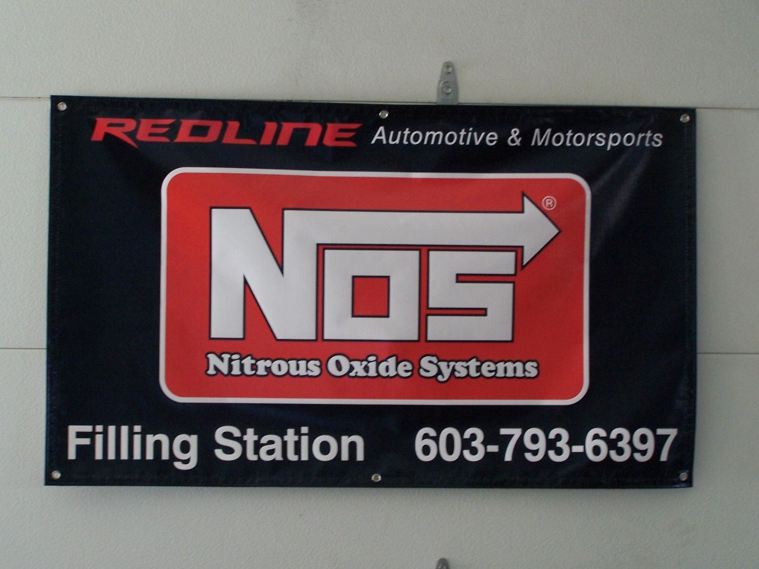 A sign for nos nitrous oxide systems filling station