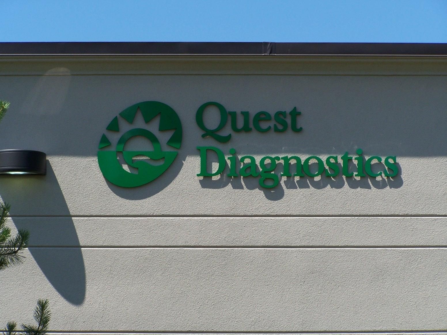A quest diagnostics sign on the side of a building