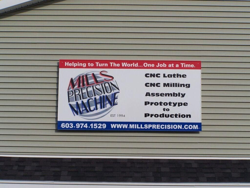 A mills precision machine sign on the side of a building