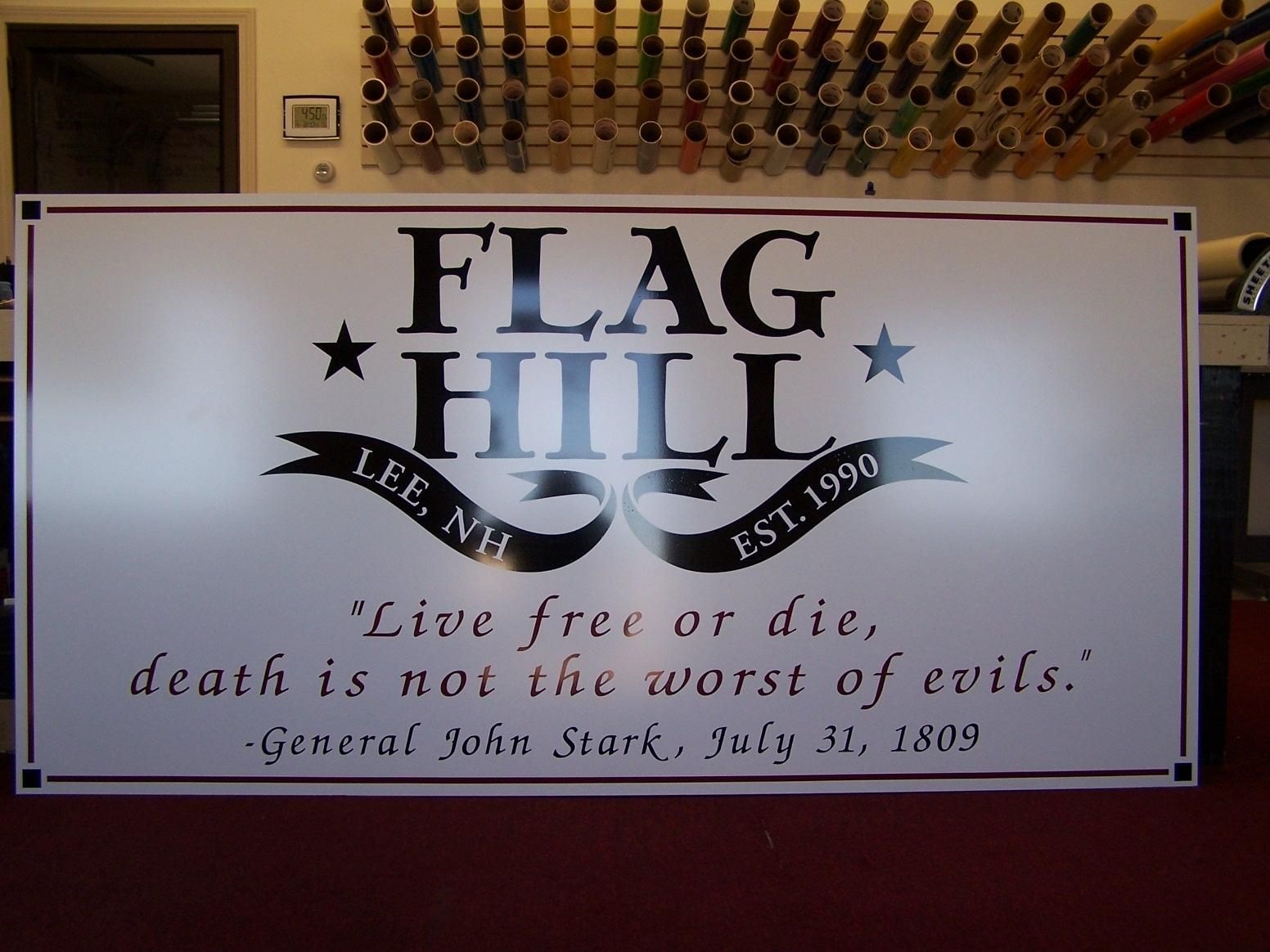 A sign that says flag hill on it