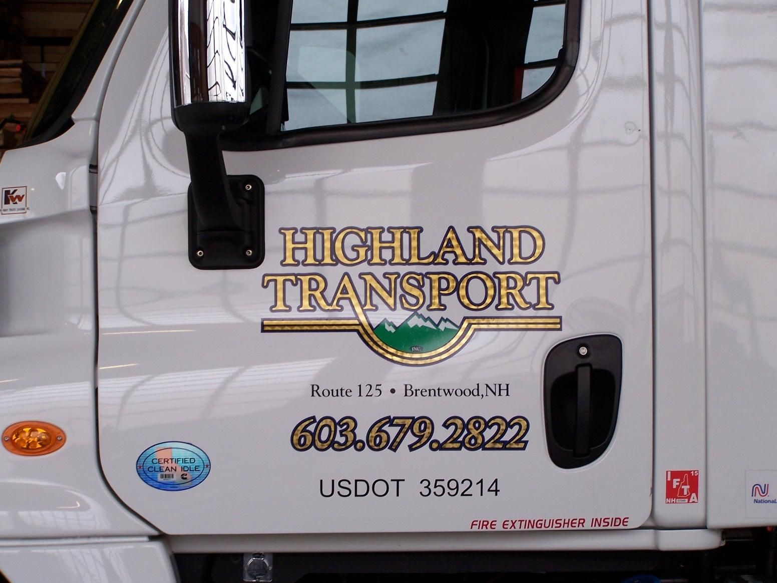 A white truck with highland transport written on the side
