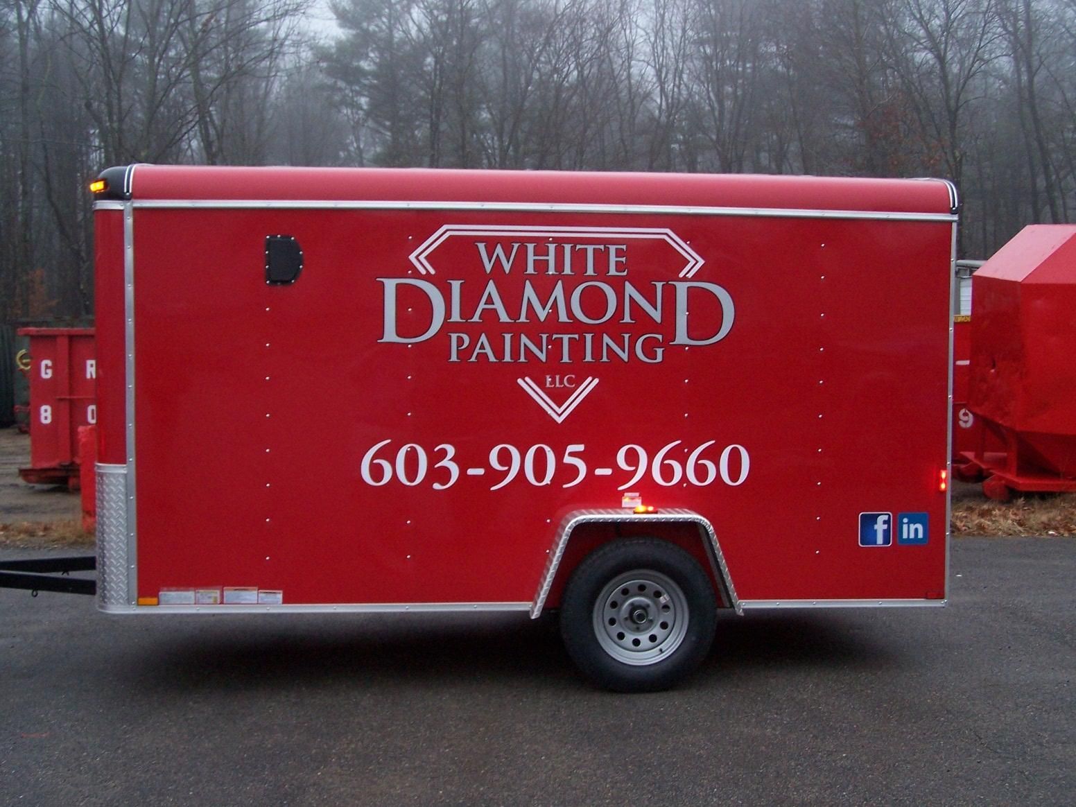 A red trailer with white diamond painting written on it