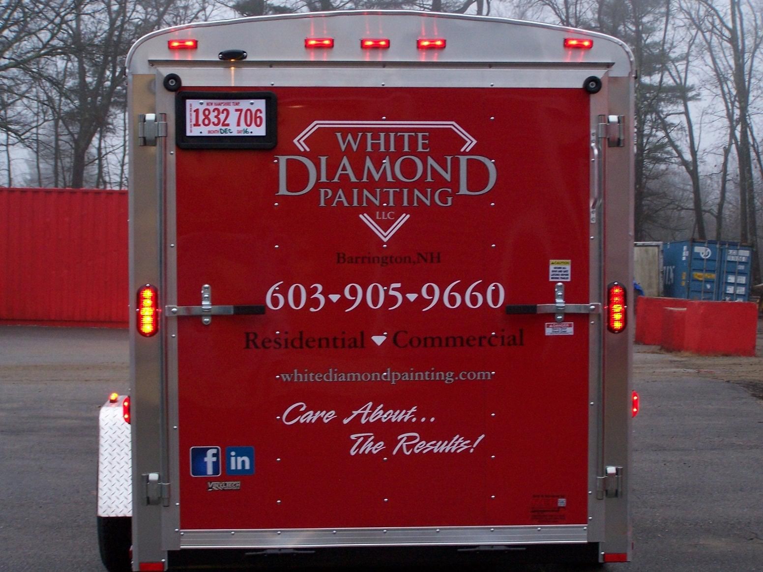 The back of a white diamond painting trailer