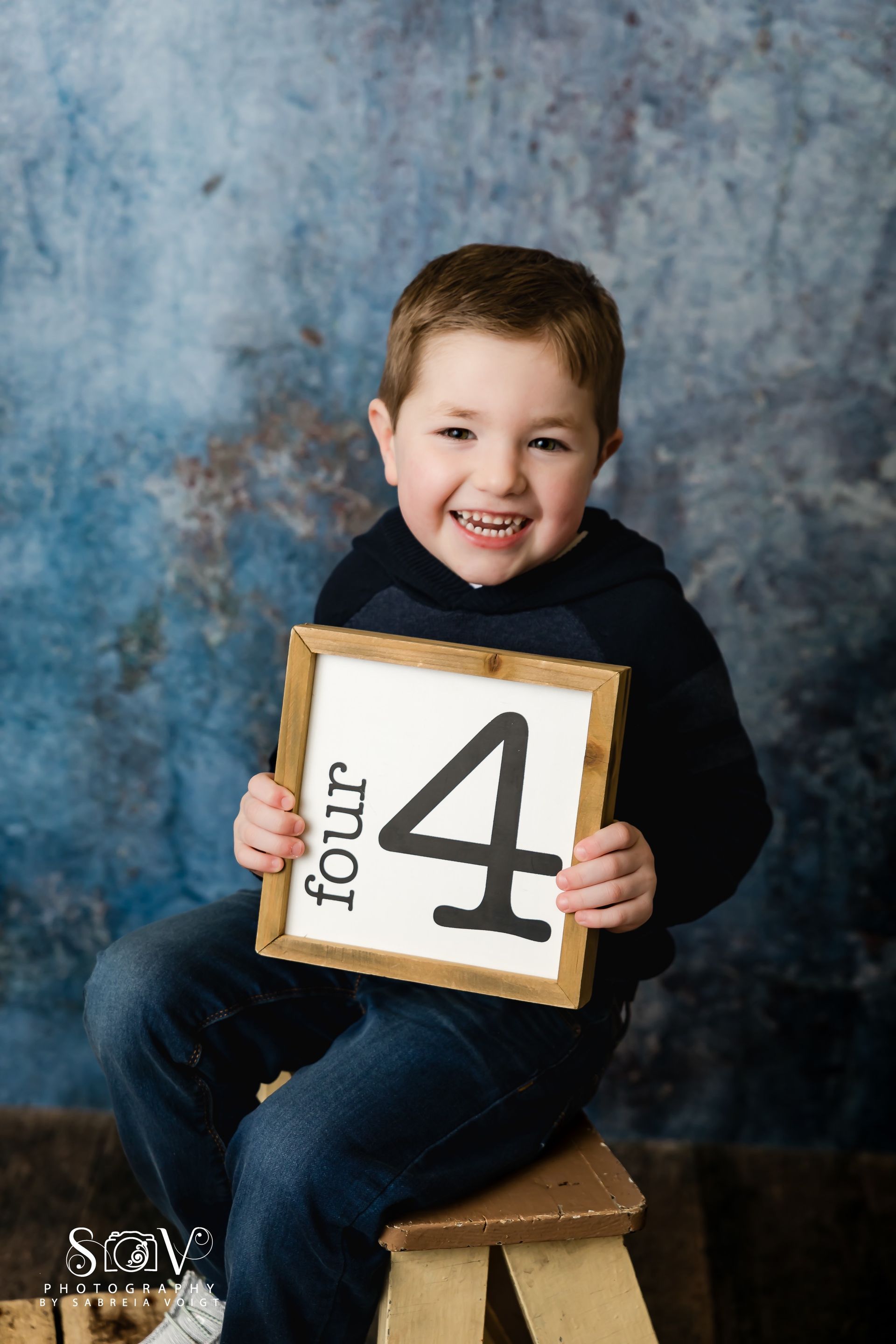 Young child holding a sign with 