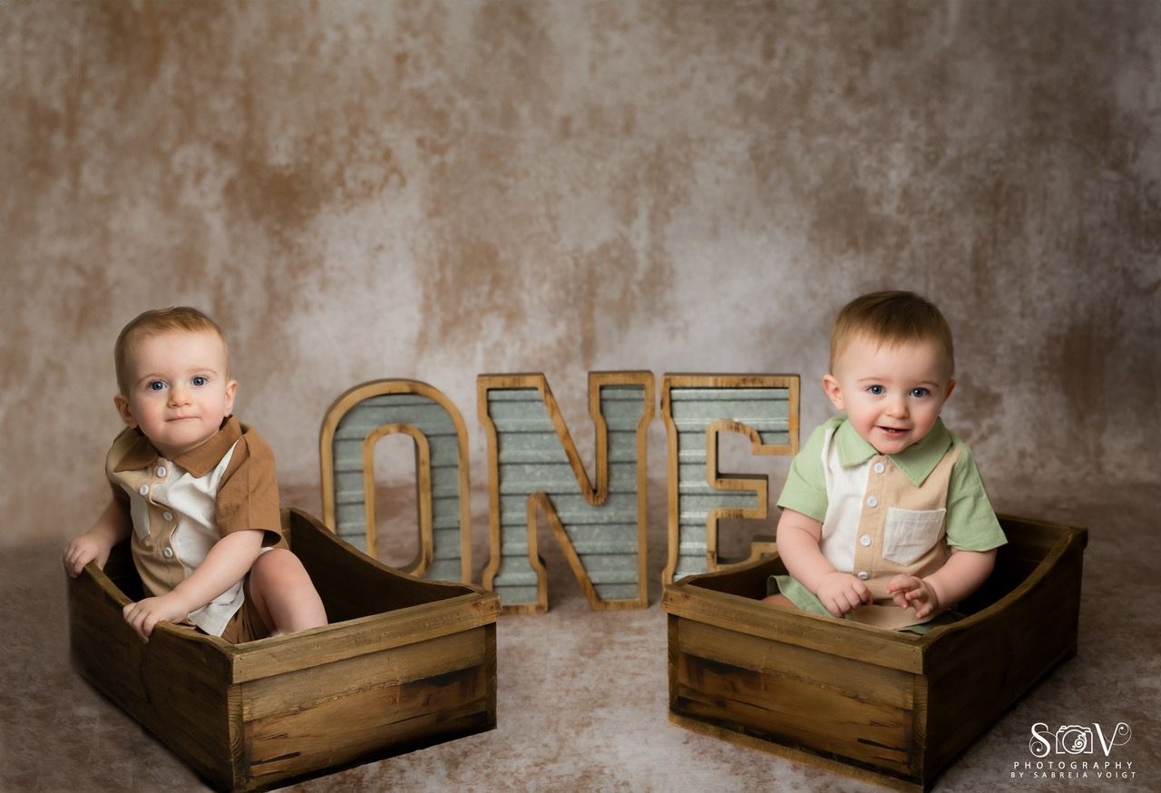 Two babies in wooden boxes, with 