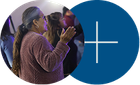 Two overlapping circles, one showing a person clapping and one blue with a white plus sign