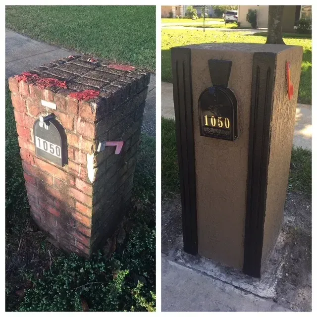 Brick and wood mailbox post with house number 1050 in a grassy yard