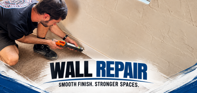 Worker repairing a beige wall with putty knife; text reads “WALL REPAIR” and “SMOOTH FINISH. STRONGER SPACES.”