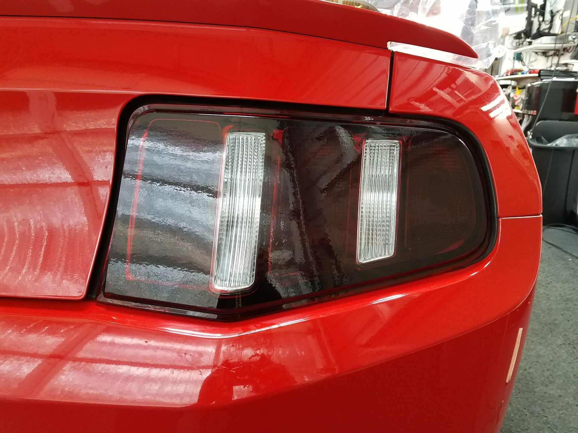 Red Mustang rear with smoked tail lights.
