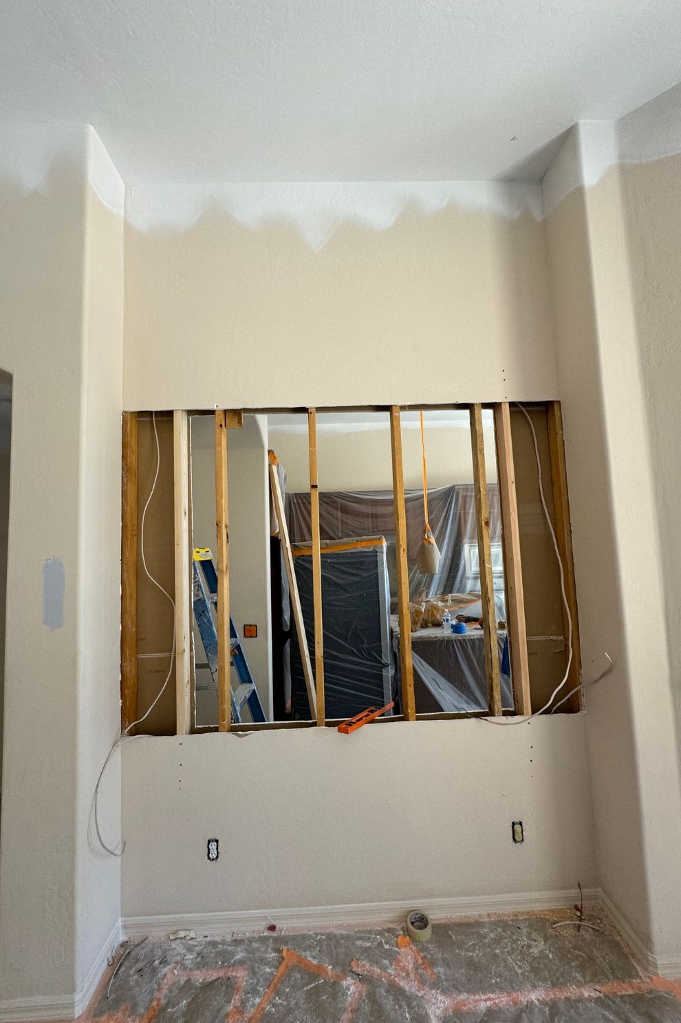 A room with a hole in the wall and a window.