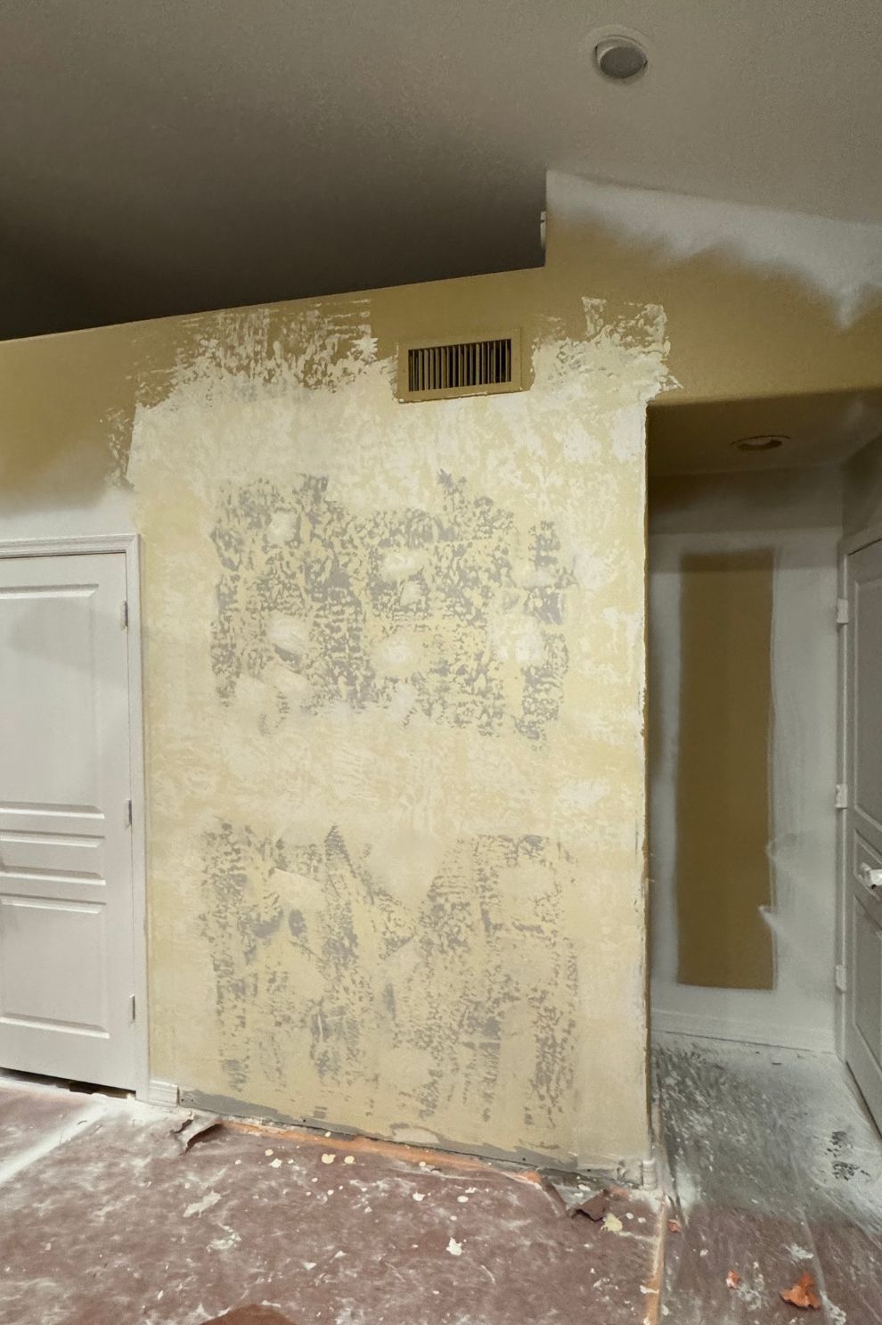 A room with a wall that is being remodeled.