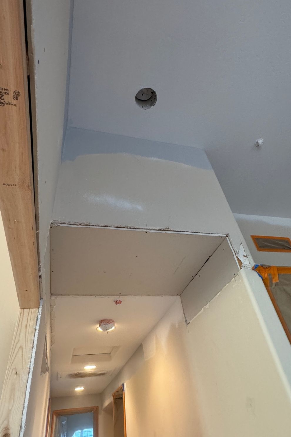 A hallway with a ceiling that is being remodeled.