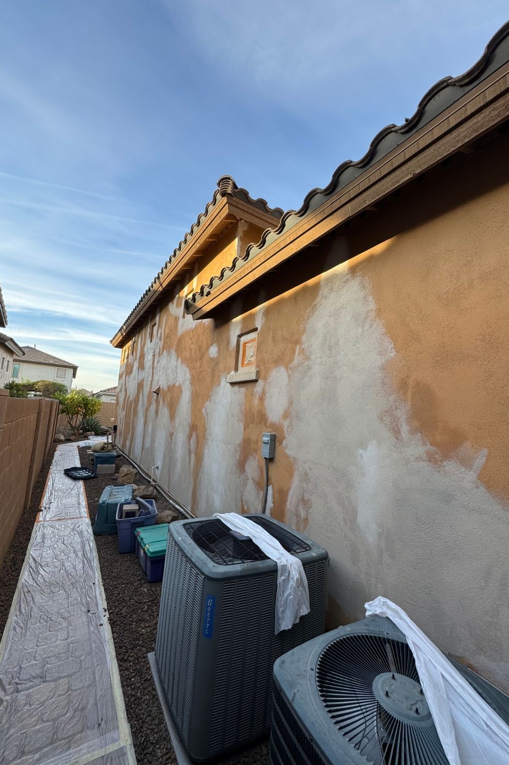 A house with a lot of air conditioners on the side of it.