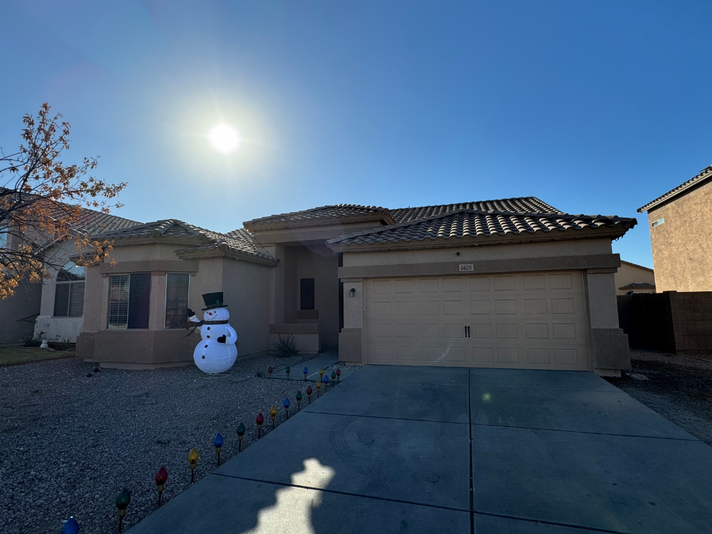 A house with a snowman in front of it