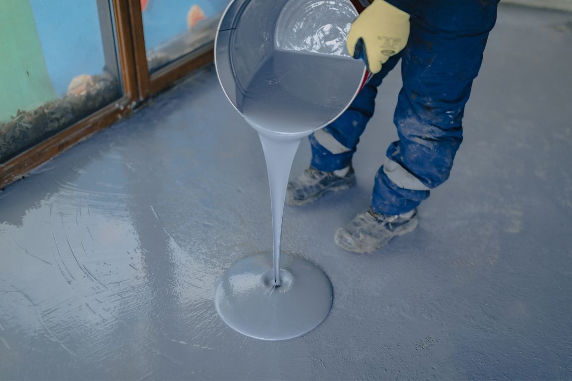A person is pouring a liquid into a container.