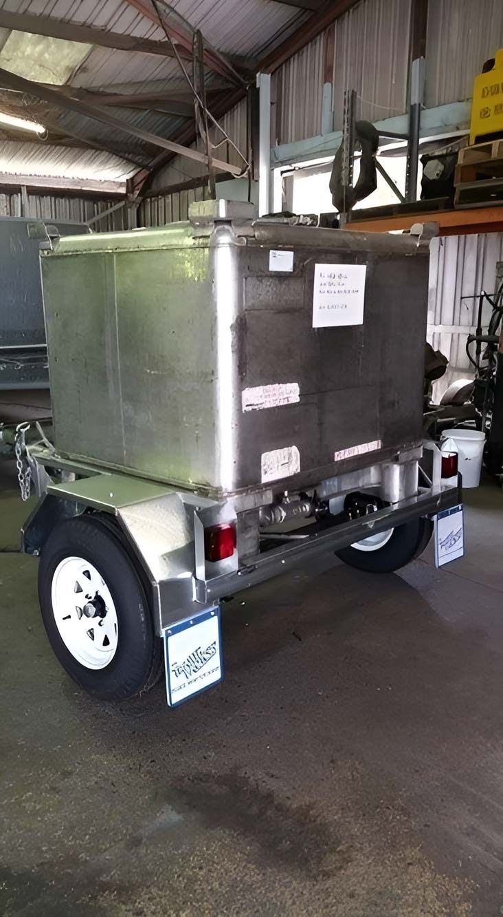 A Trailer With A Large Metal Box On It Is Parked In A Garage — Hastings Trailer Centre in Port Macquarie, NSW